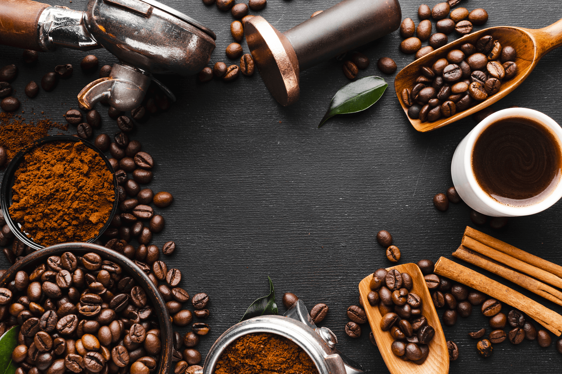 Coffee beans and brewing tools arranged on a dark surface